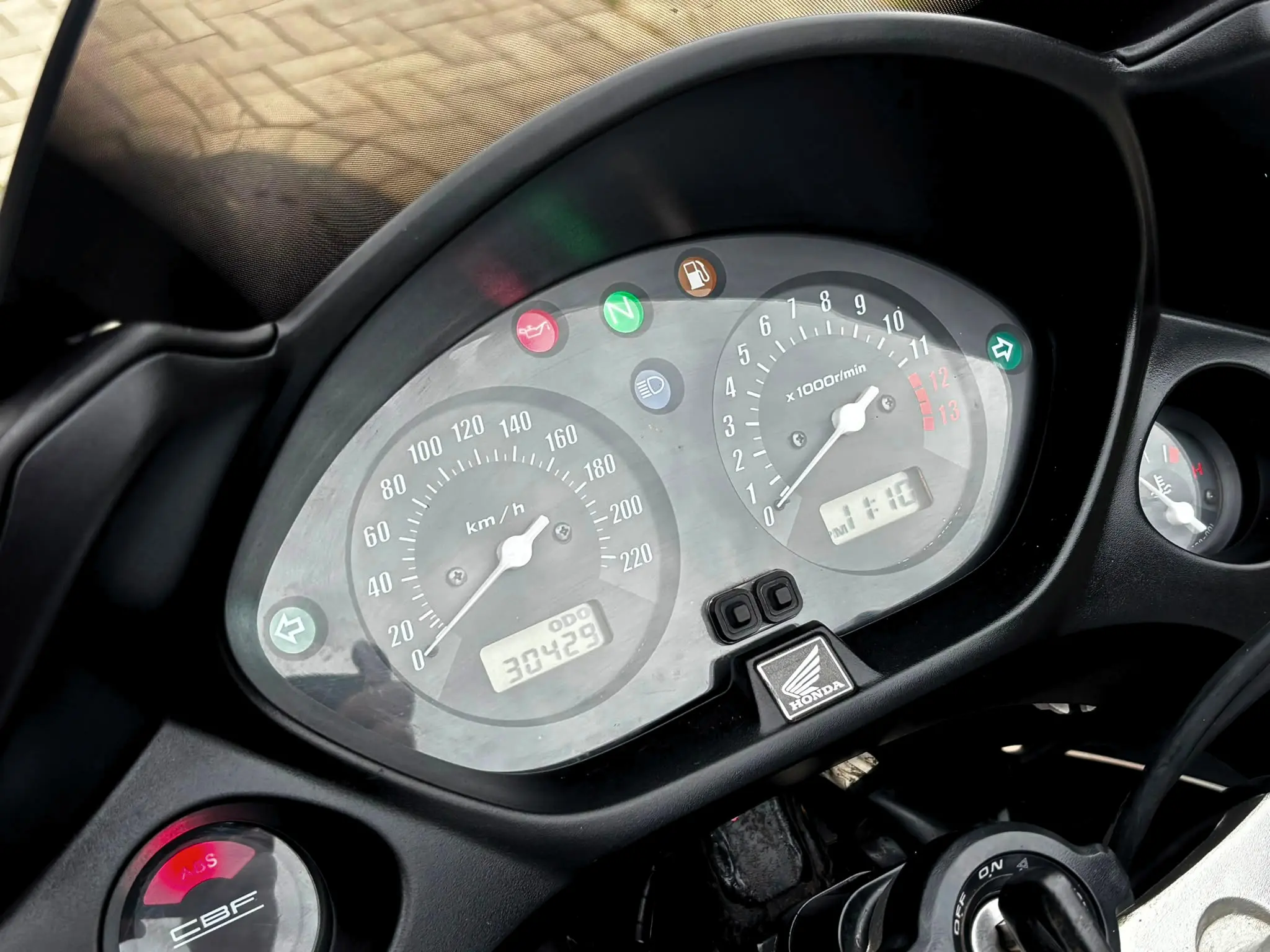 Cockpit und Instrumente einer Honda CBF 600 SA ABS mit analogem Tacho und Kilometerstand während der Fahrzeugaufbereitung.